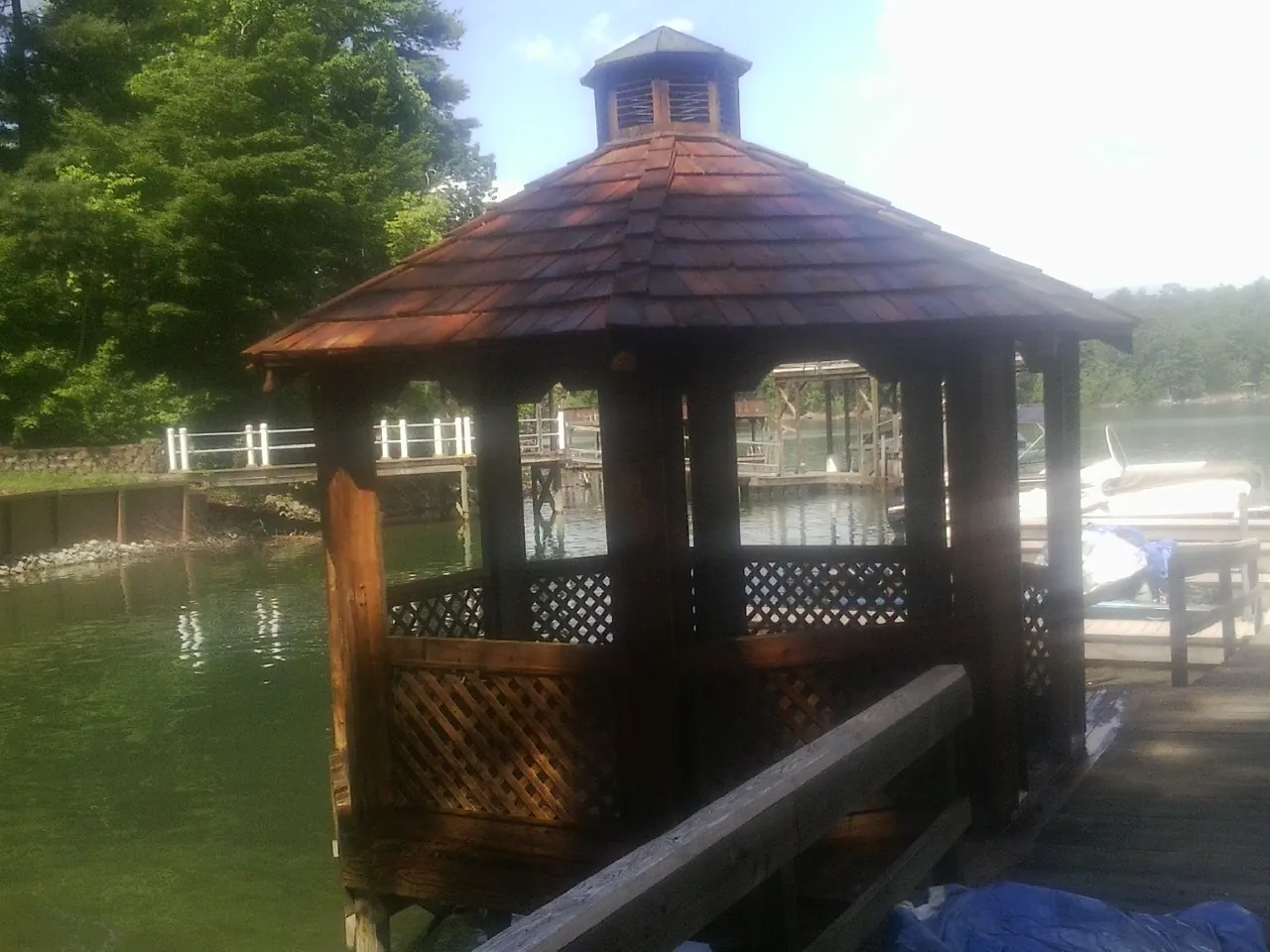 Cedar shake gazebo roof rebuilt on a lake dock in Keno